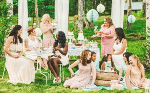 women-having-a-garden-party-with-dessert-table